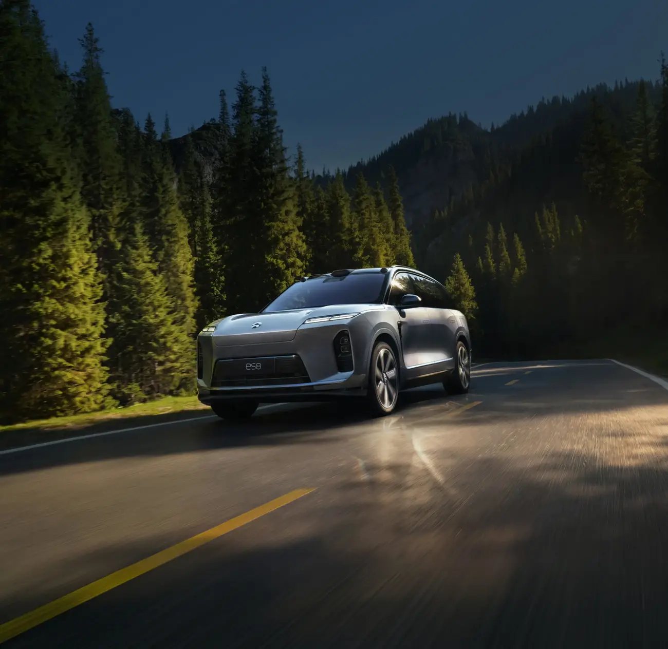 Silver NIO ES8 driving on a mountain road